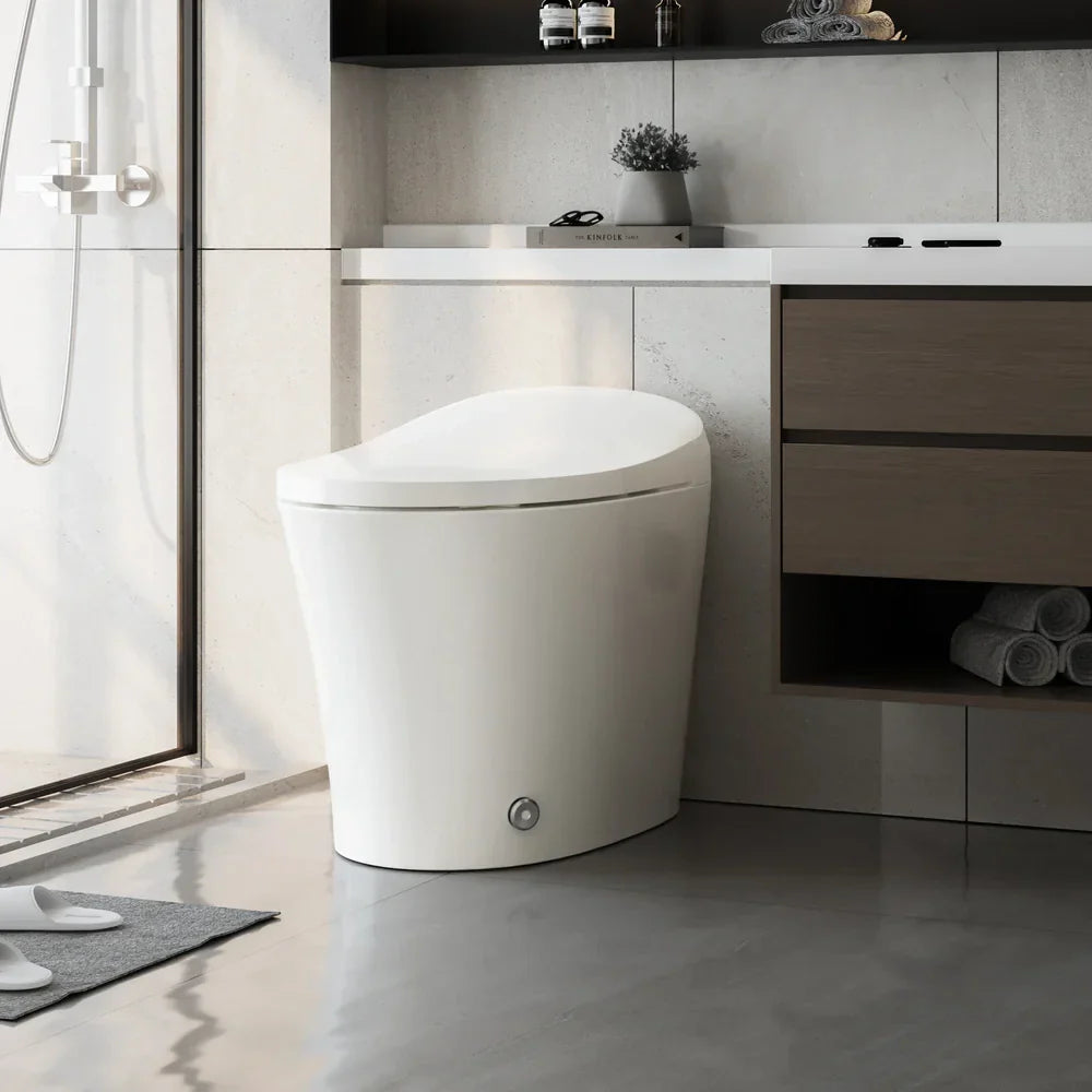 Modern smart toilet beside a vanity in a bright bathroom, featuring a sleek, space-efficient build that elevates daily hygiene experiences.
