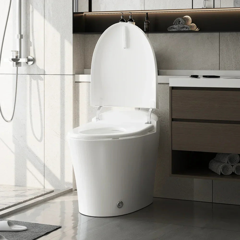 A white one-piece smart toilet with an open lid sits in a modern bathroom, alongside a shower, vanity, and gray tile accents.