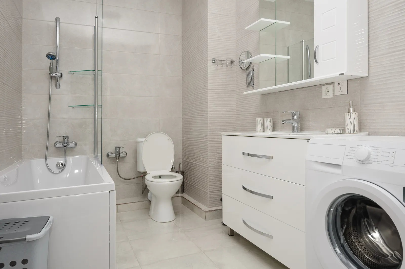 A compact bathroom features a space-efficient smart toilet alongside a bathtub.