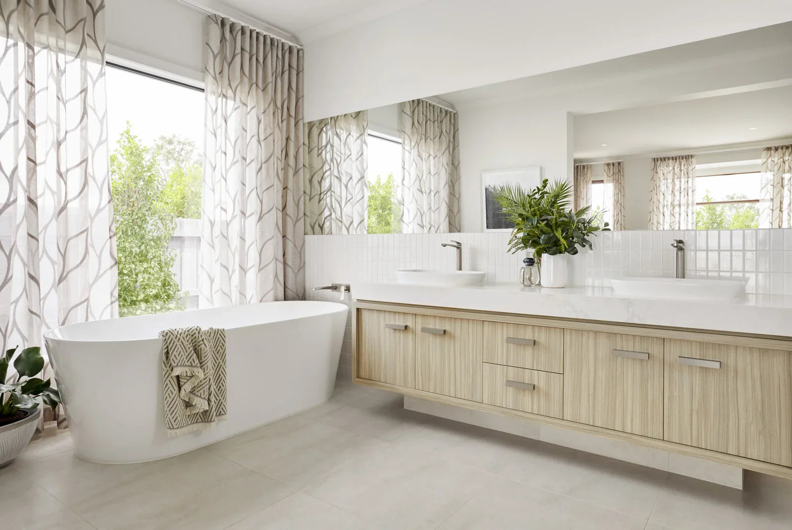 White freestanding bathtub in a modern bathroom, providing a relaxing bathing experience.