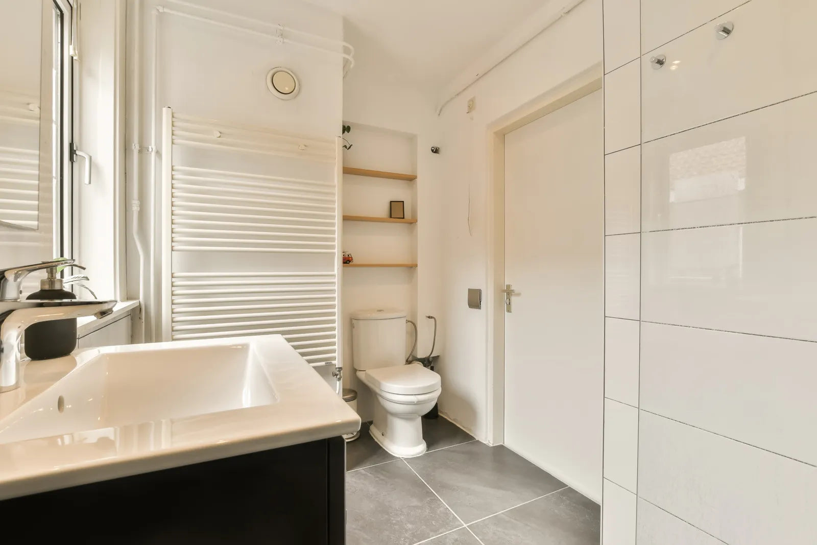 Clean modern residential bathroom with standard installed toilet fixture