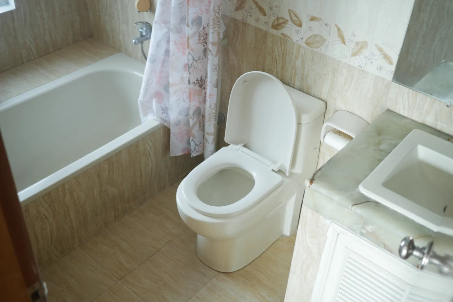Small bathroom layout with an alcove bathtub, toilet, and sink, illustrating real-world clearance and daily use considerations for compact spaces.