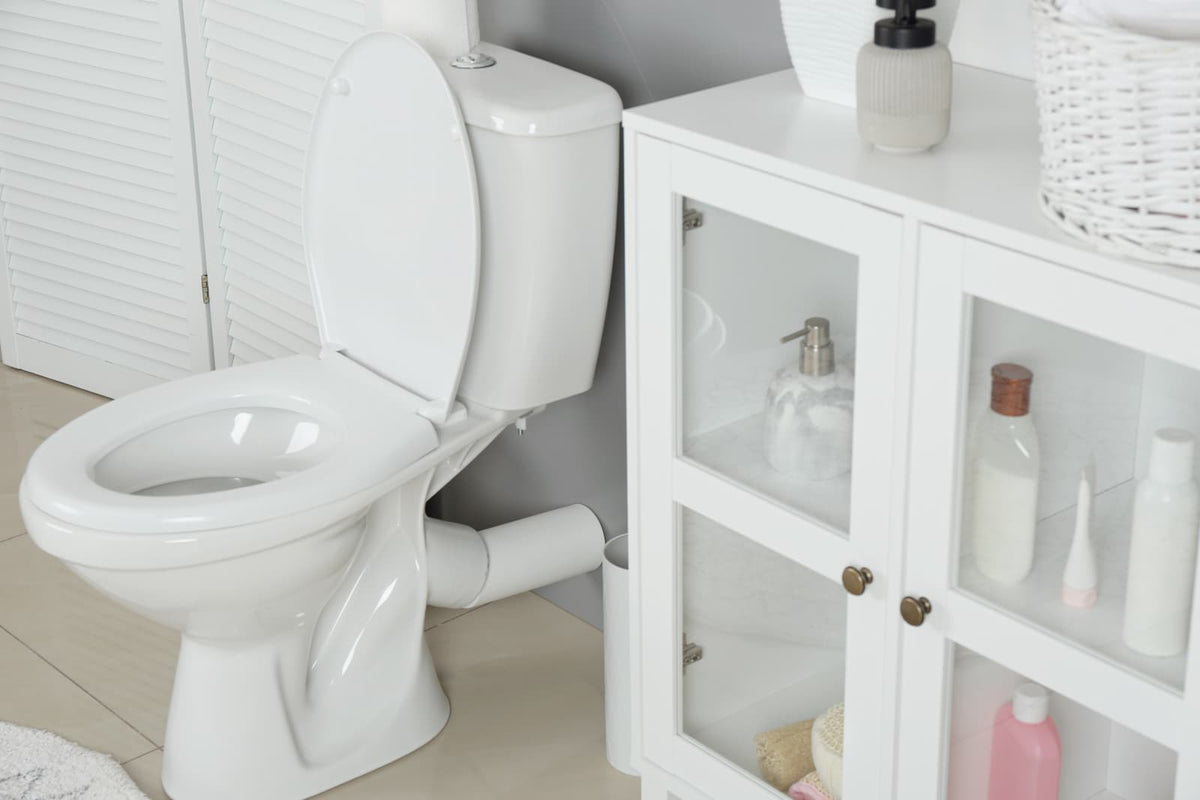 White two-piece toilet with the seat raised and the tank mounted behind the bowl.