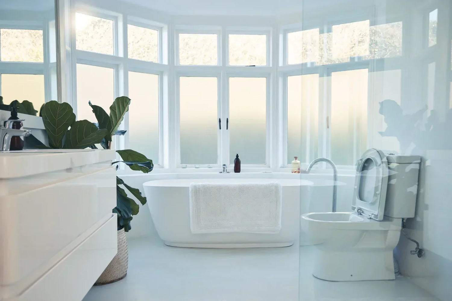 Bright minimalist bathroom with a smart toilet, highlighting a clean, user-friendly space for smart toilet operation.