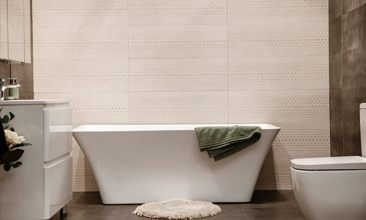 A modern bathroom displays a freestanding tub, which requires moving plumbing for proper installation.