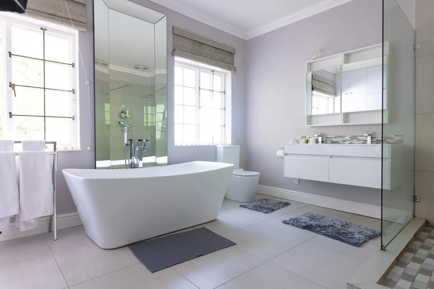 Bright modern bathroom with a sleek oval freestanding tub, perfect for ergonomic solo soaking and soft visual focal points.