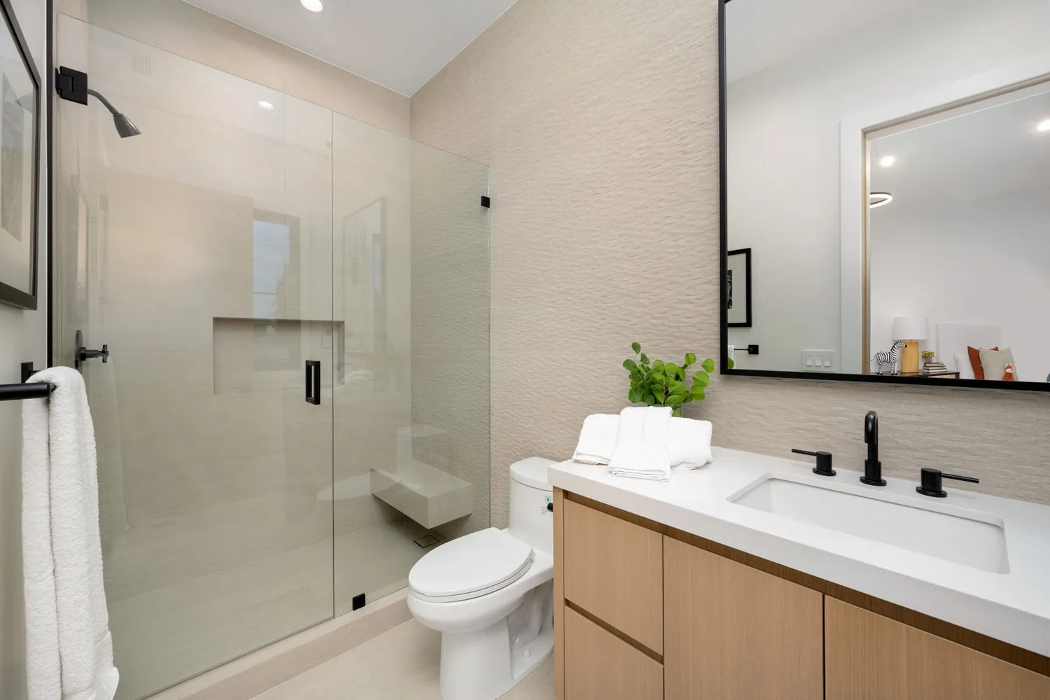 Modern neutral-toned bathroom features a pressure-assisted upgrade.