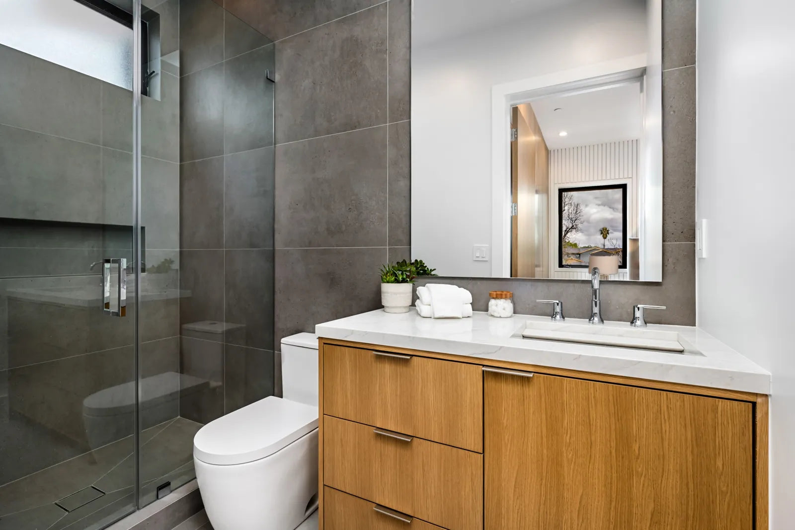 Modern bathroom featuring an elongated toilet, showcasing its sleek, contemporary design and comfort-focused shape.