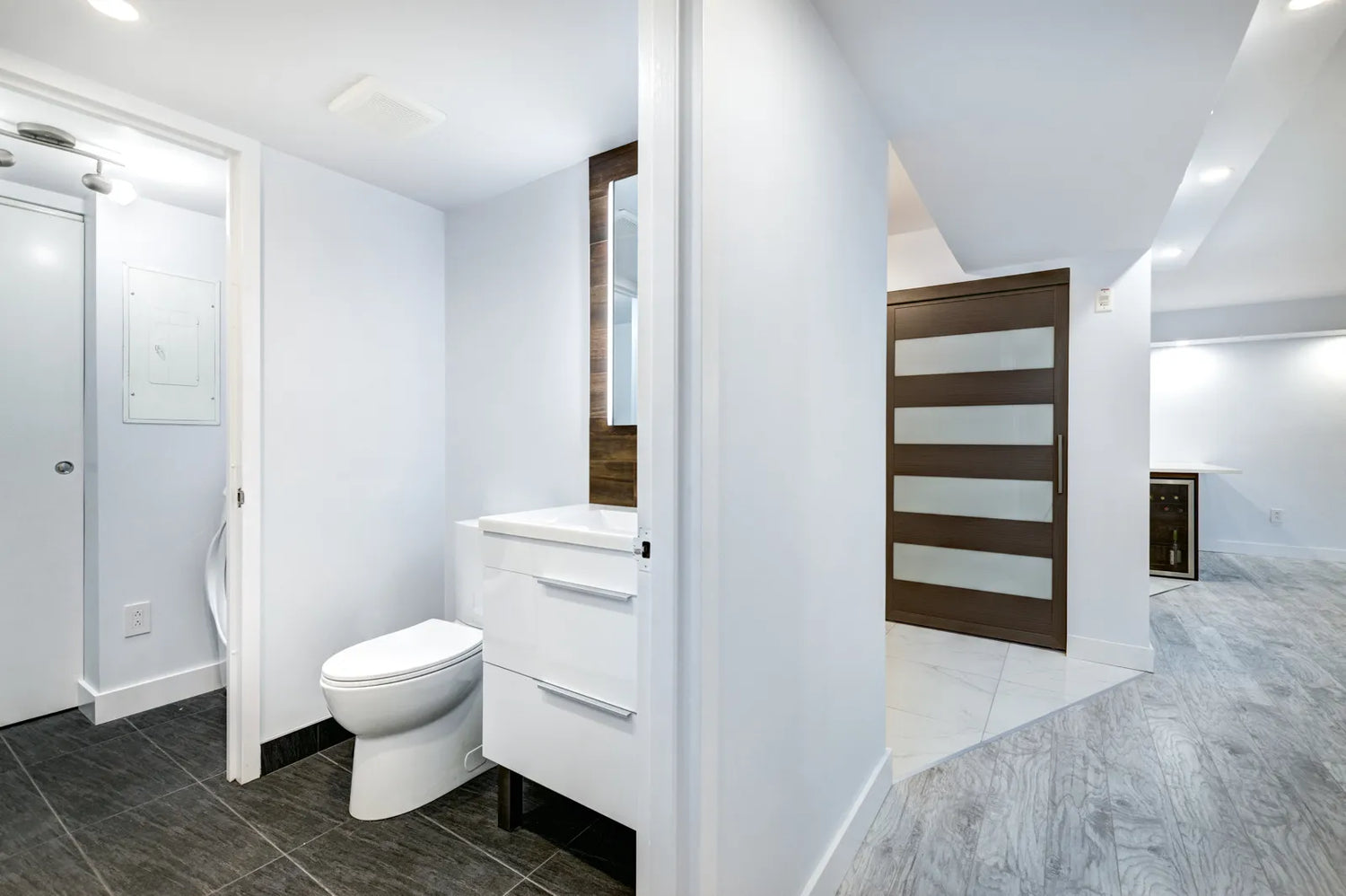 A modern bathroom showcases a self-cleaning toilet installation.