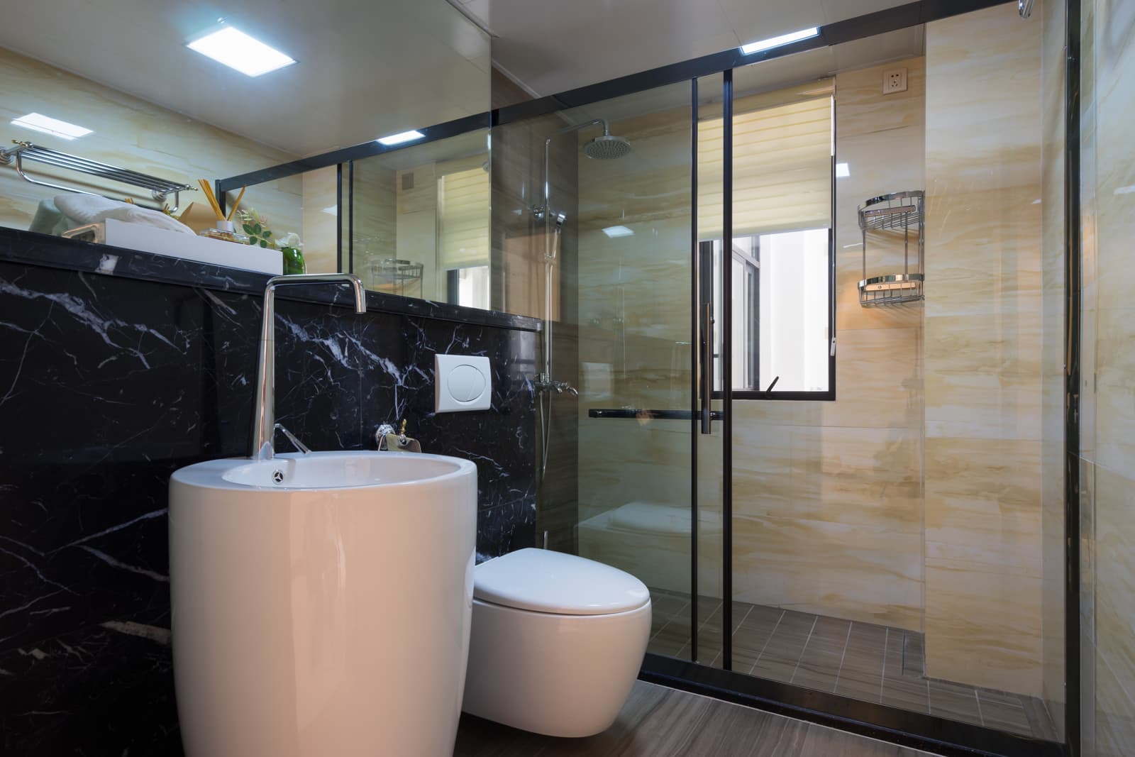 Black-framed sliding shower door showing the track, glass panels, and handle alignment