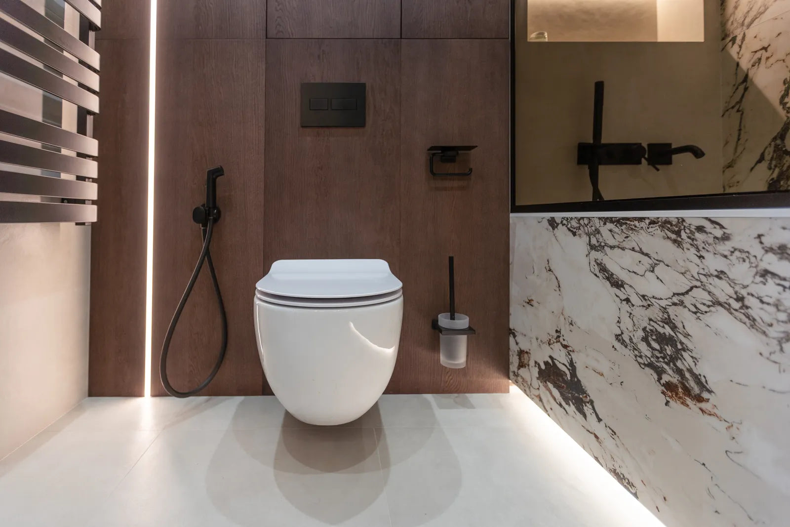 A sleek smart toilet sits in a modern bathroom, requiring battery backup for uninterrupted function.