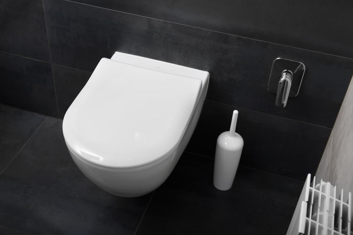 Compact bidet-style toilet installed in a small residential bathroom
