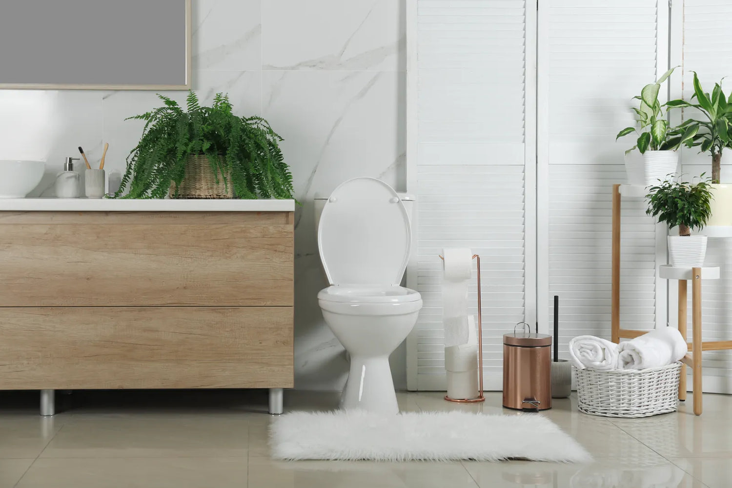 Modern bathroom with a white toilet, plants, and organized storage, illustrating a well-maintained space for a reliable smart toilet.