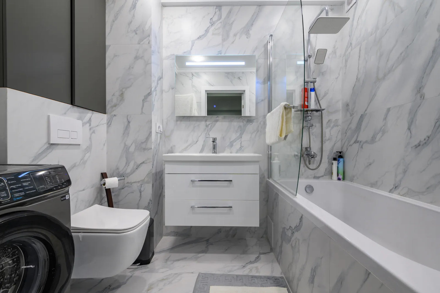 Modern bathroom with a wall-mounted smart toilet, showcasing a finished setup with heated seat and built-in dryer features.