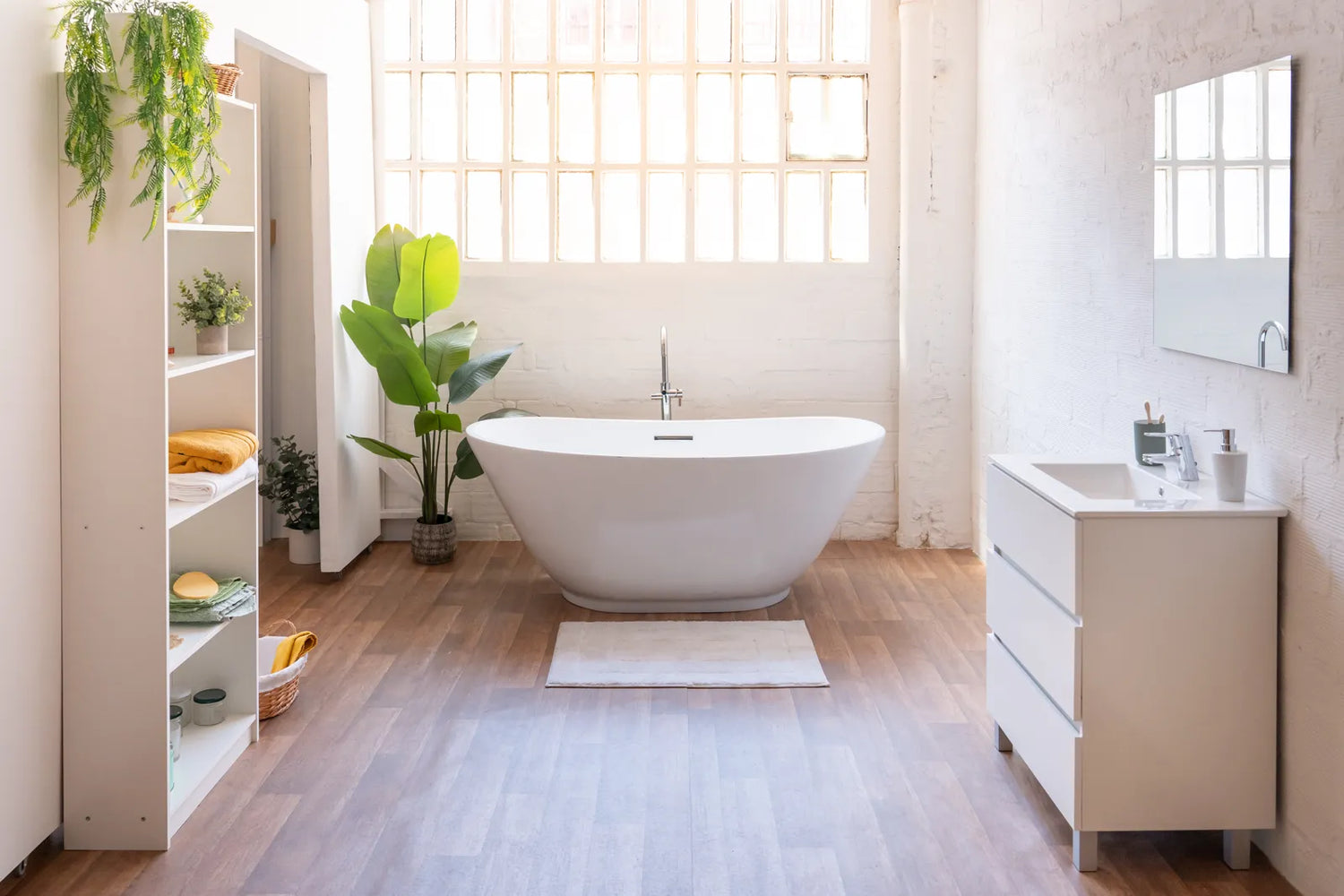 A large freestanding soaking tub sits in a bright, spacious bathroom.
