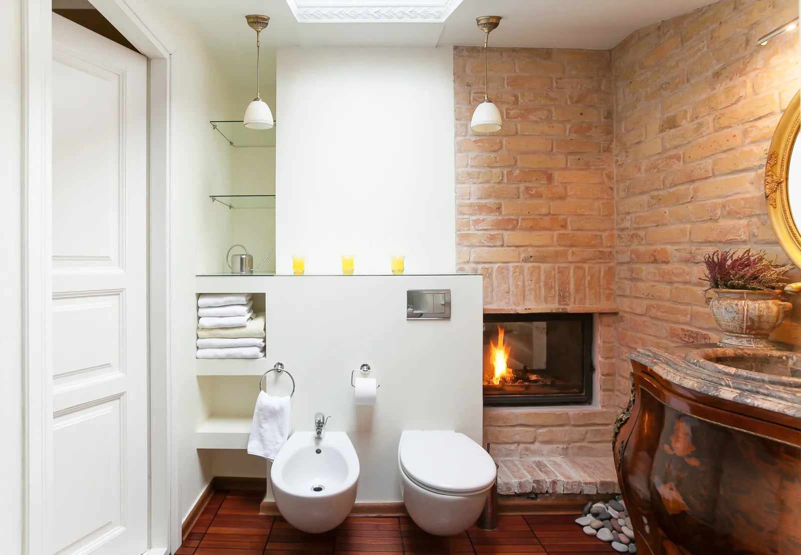 A stylish bathroom houses a bidet and toilet, requiring winter maintenance to prevent freezing issues.