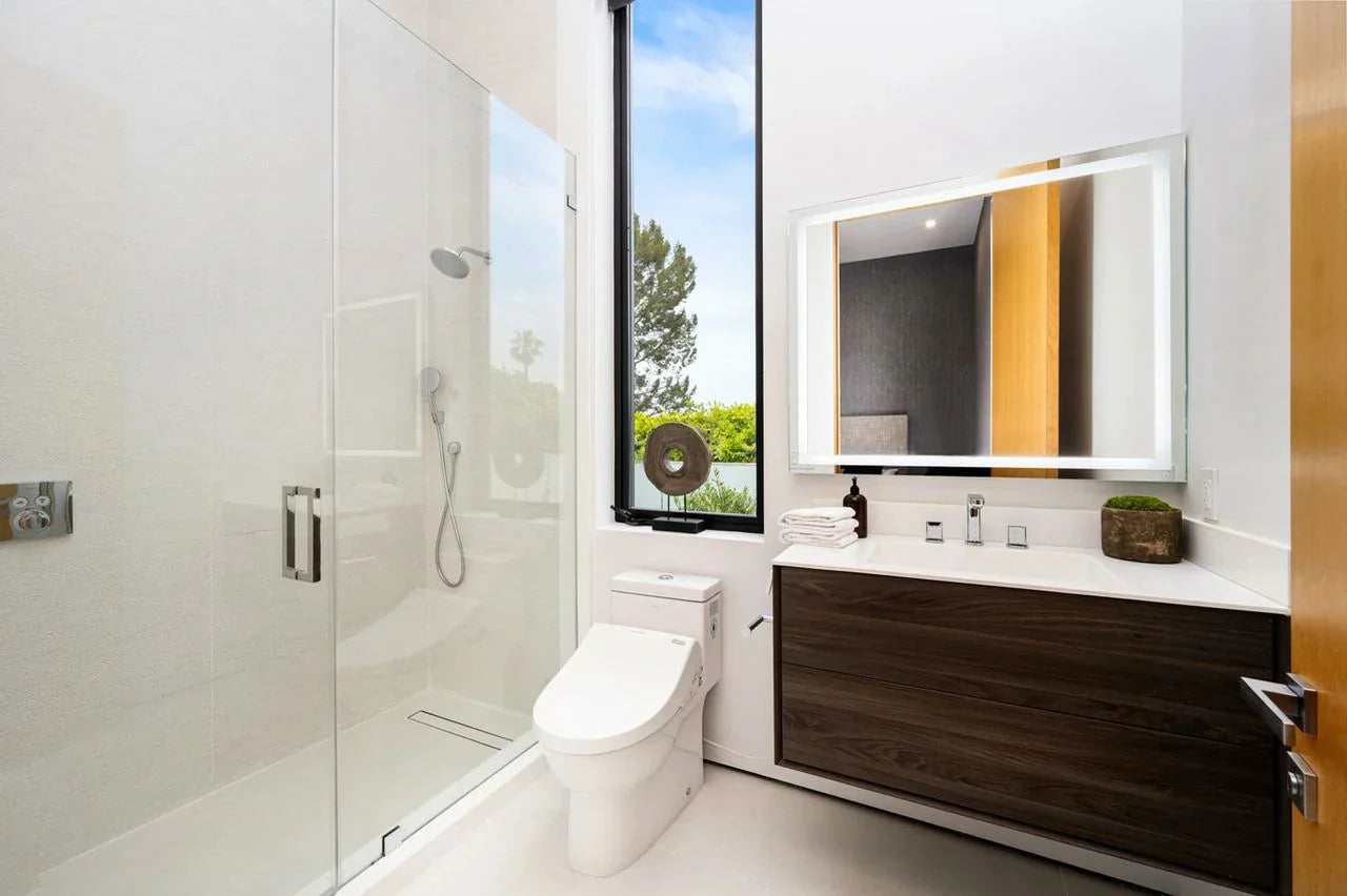 Modern bathroom with tornado flush smart toilet, glass shower, and dark wood vanity.