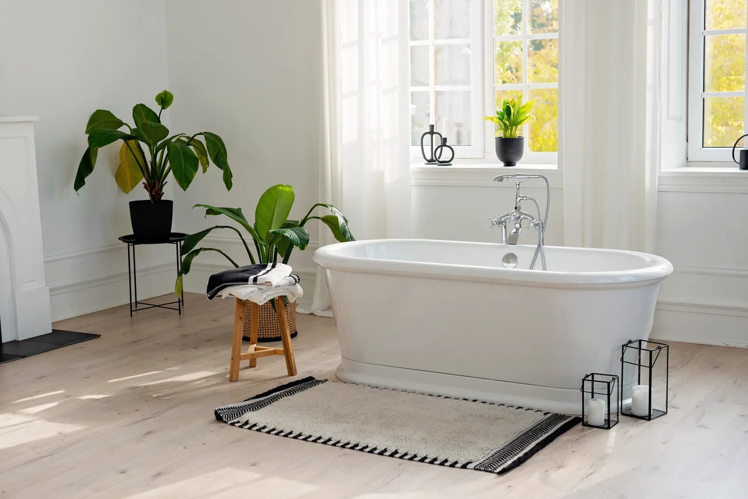Bright bathroom with a white freestanding tub, showcasing the sleek design shared by both acrylic and stone resin options.