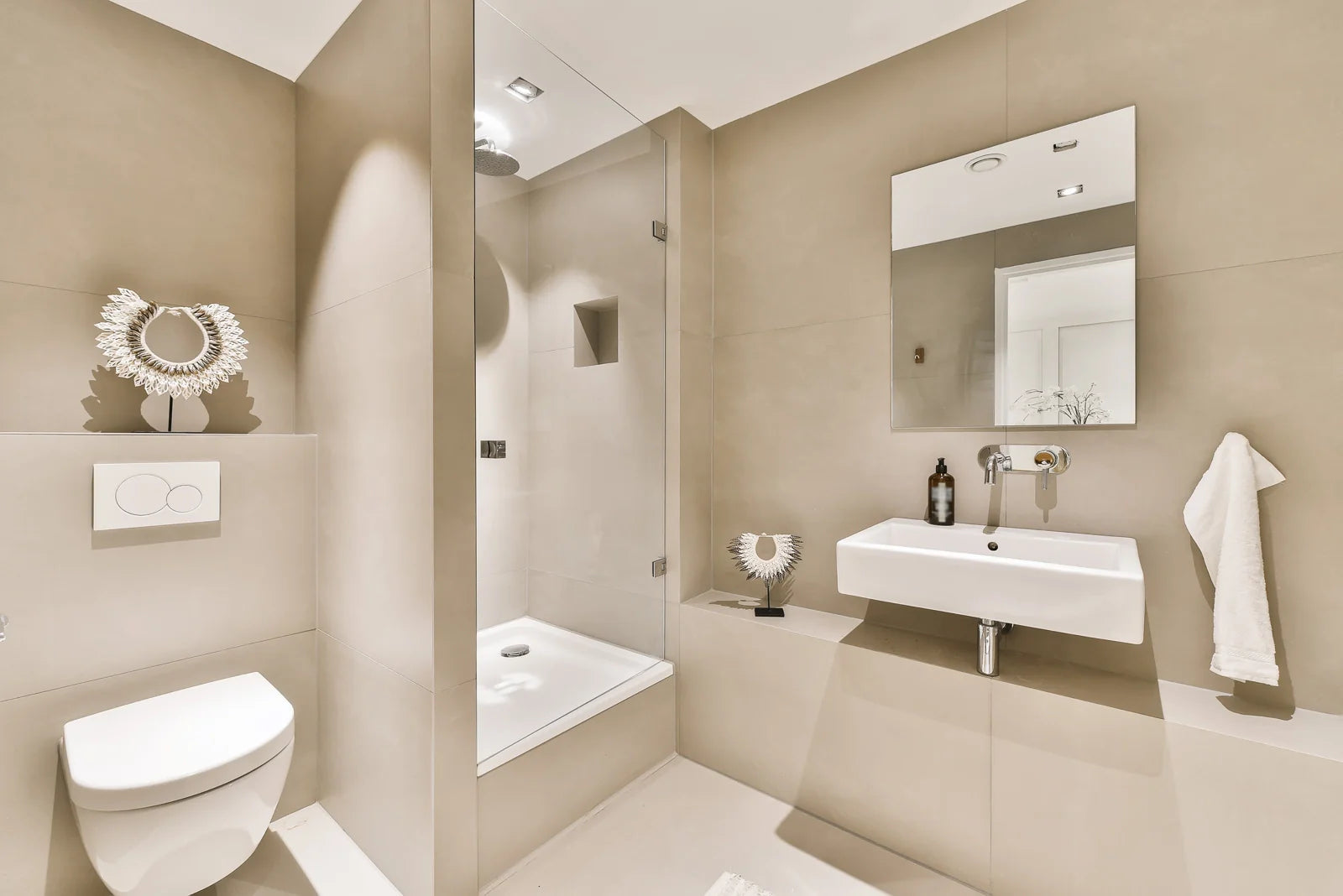 A modern bathroom with a wall-hung smart toilet featuring an ADA-compliant dual flush plate.