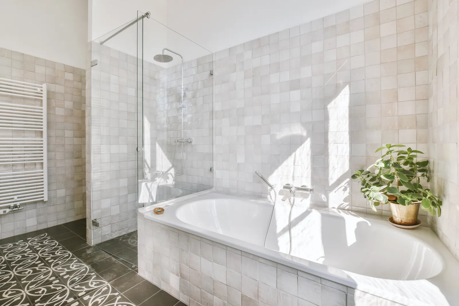 A modern bathroom features both a bathtub and a shower enclosure.