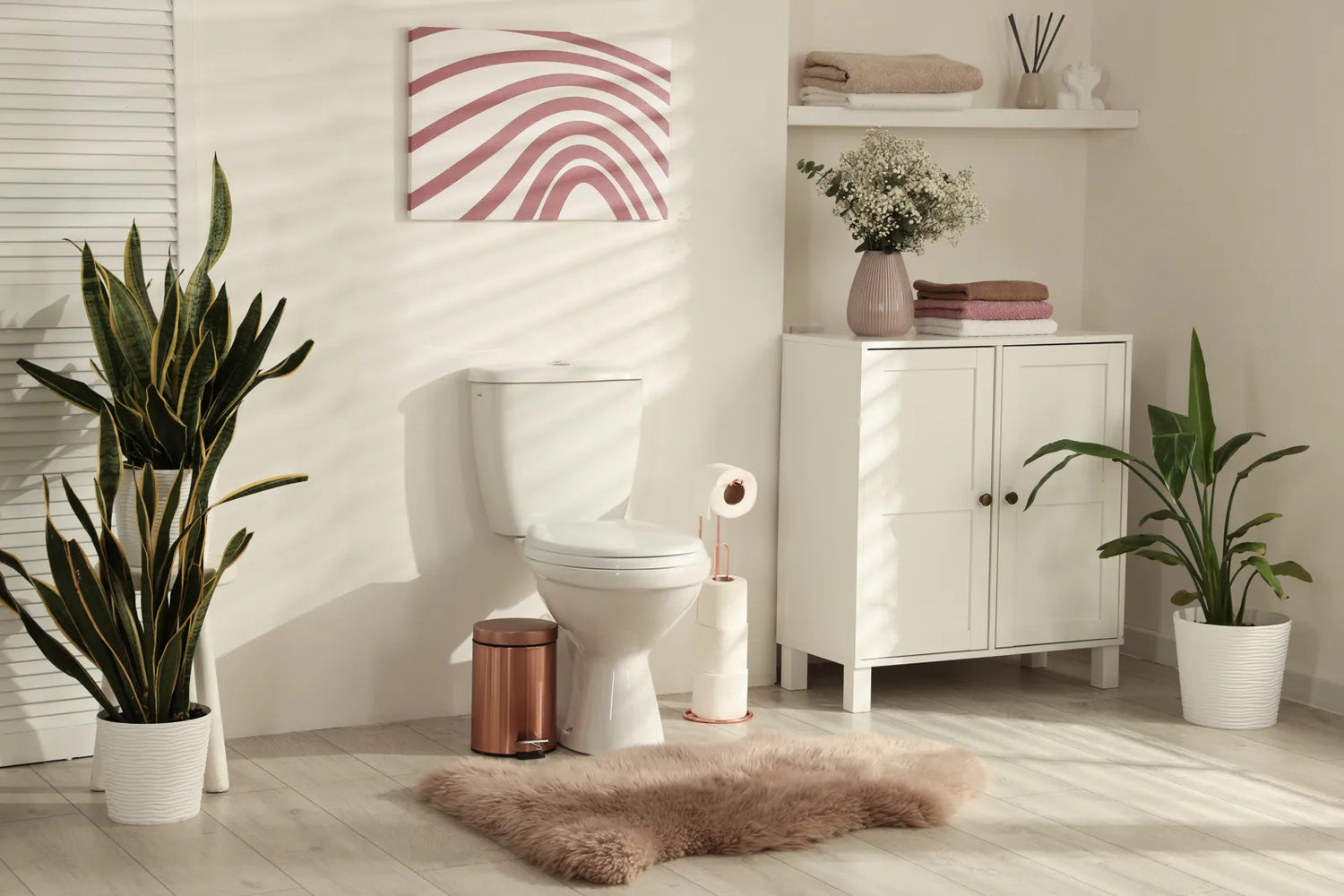 Bright bathroom with toilet, plants, and soft postpartum decor