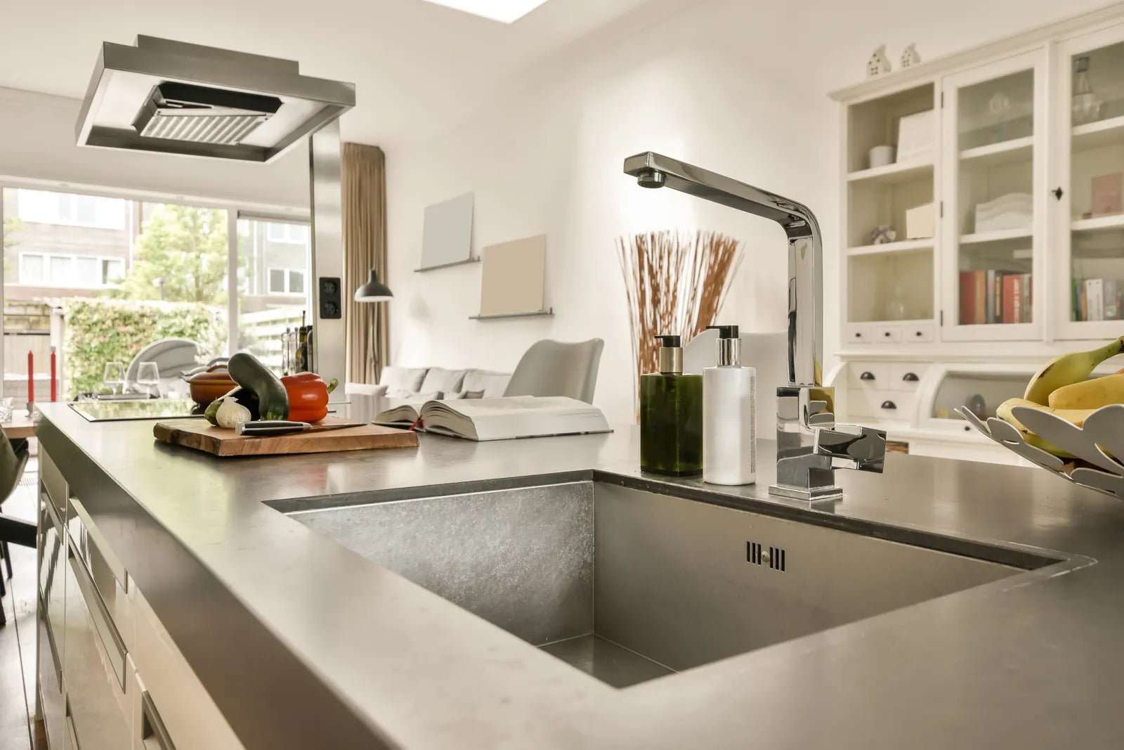 Sleek stainless steel undermount sink in an open-concept kitchen, offering a seamless, modern look.
