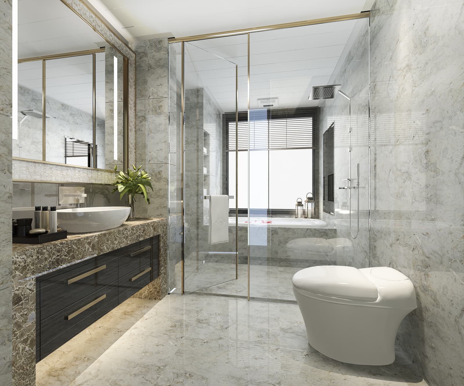 This luxury marble bathroom features a frameless glass shower enclosure fitted with sleek brushed gold metal framing.