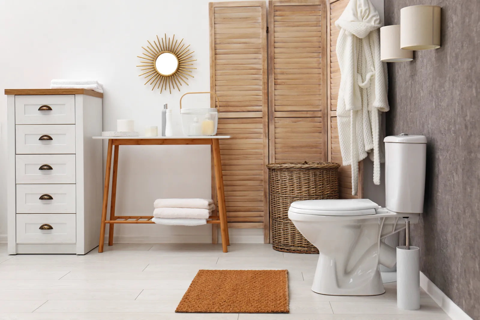 Bright minimalist bathroom with a white toilet, wooden decor, and natural light.
