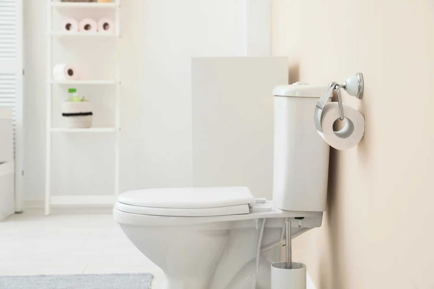A clean white toilet in a bathroom, the starting point for draining its bowl water.