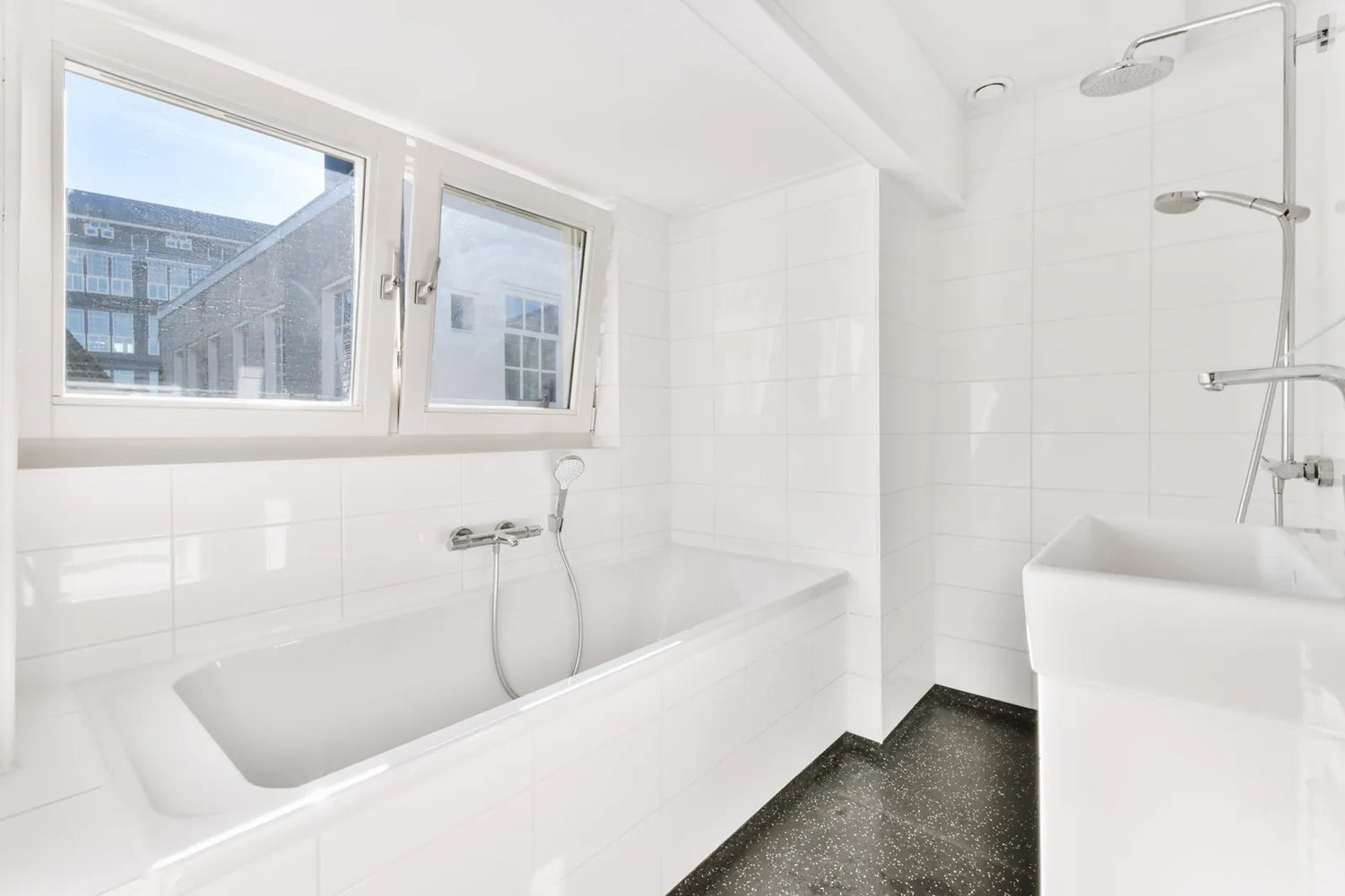 DIY worker measuring tile size during acrylic bathtub installation in a standard bathroom alcove