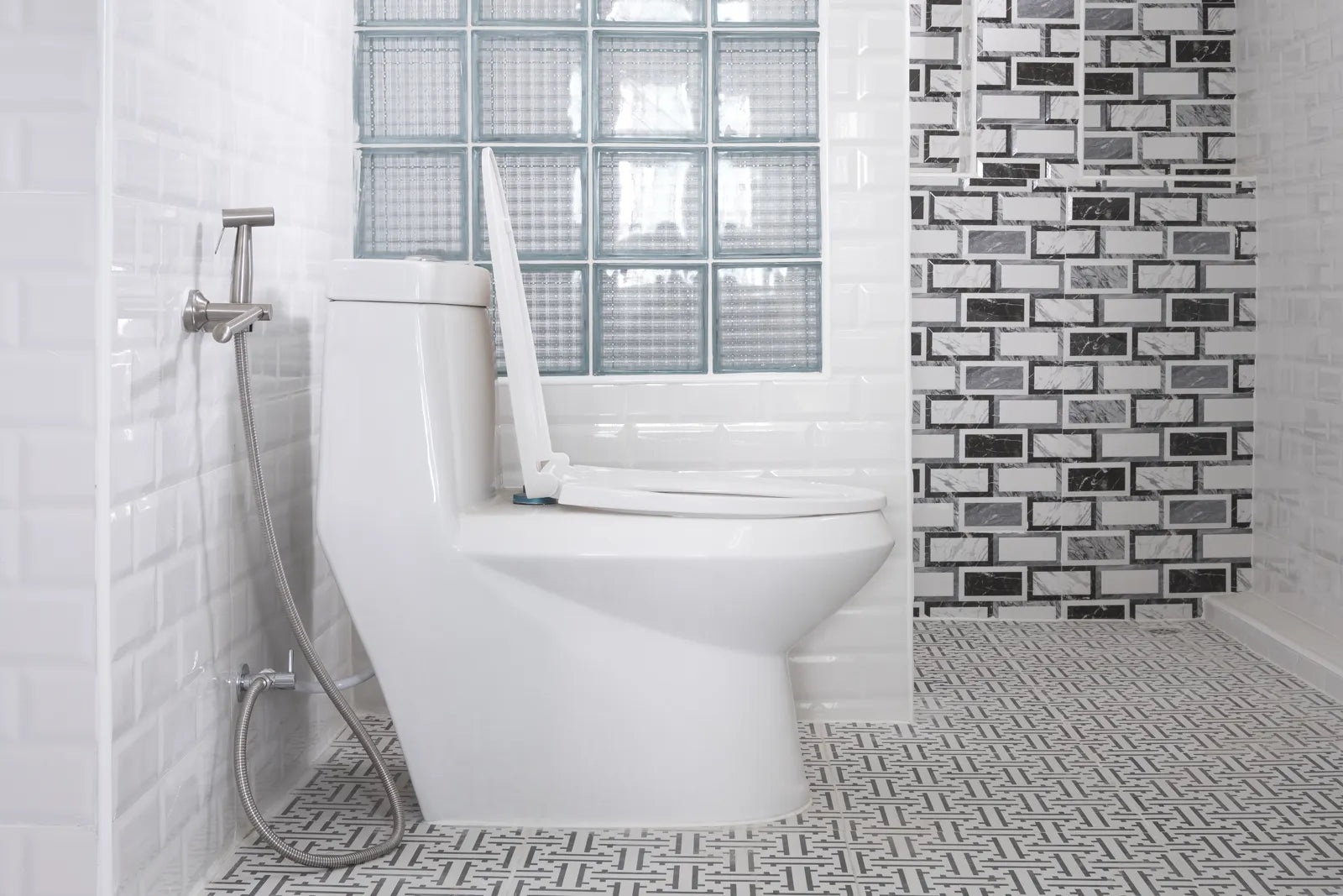 A one-piece toilet with a bidet sprayer, showing its dimensions in a tiled bathroom.