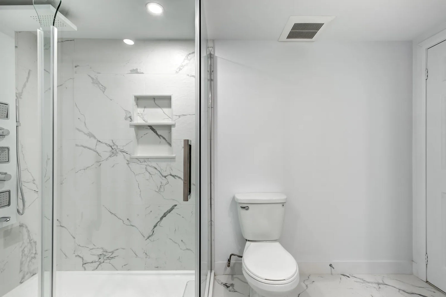 A modern bathroom displays a glass shower door with standard thickness.