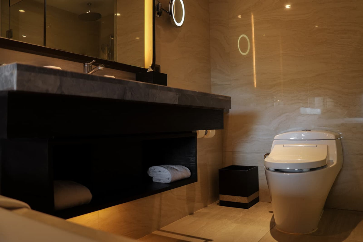 Modern smart toilet installed in an upscale bathroom with integrated electronic features