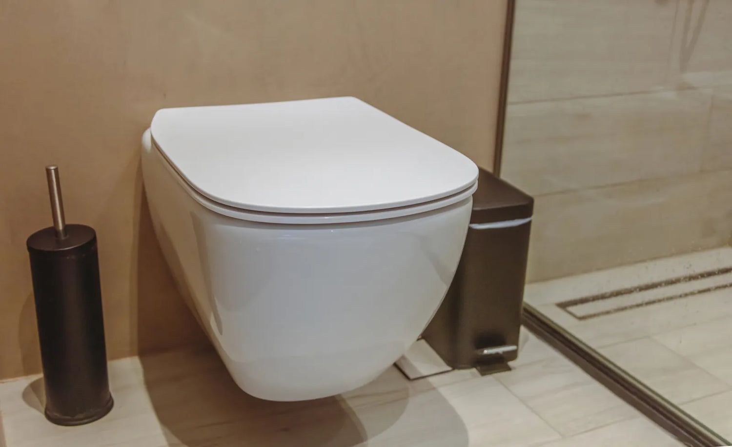A sleek wall-mounted smart toilet in a modern bathroom, designed for space-saving and hygienic use with advanced features.