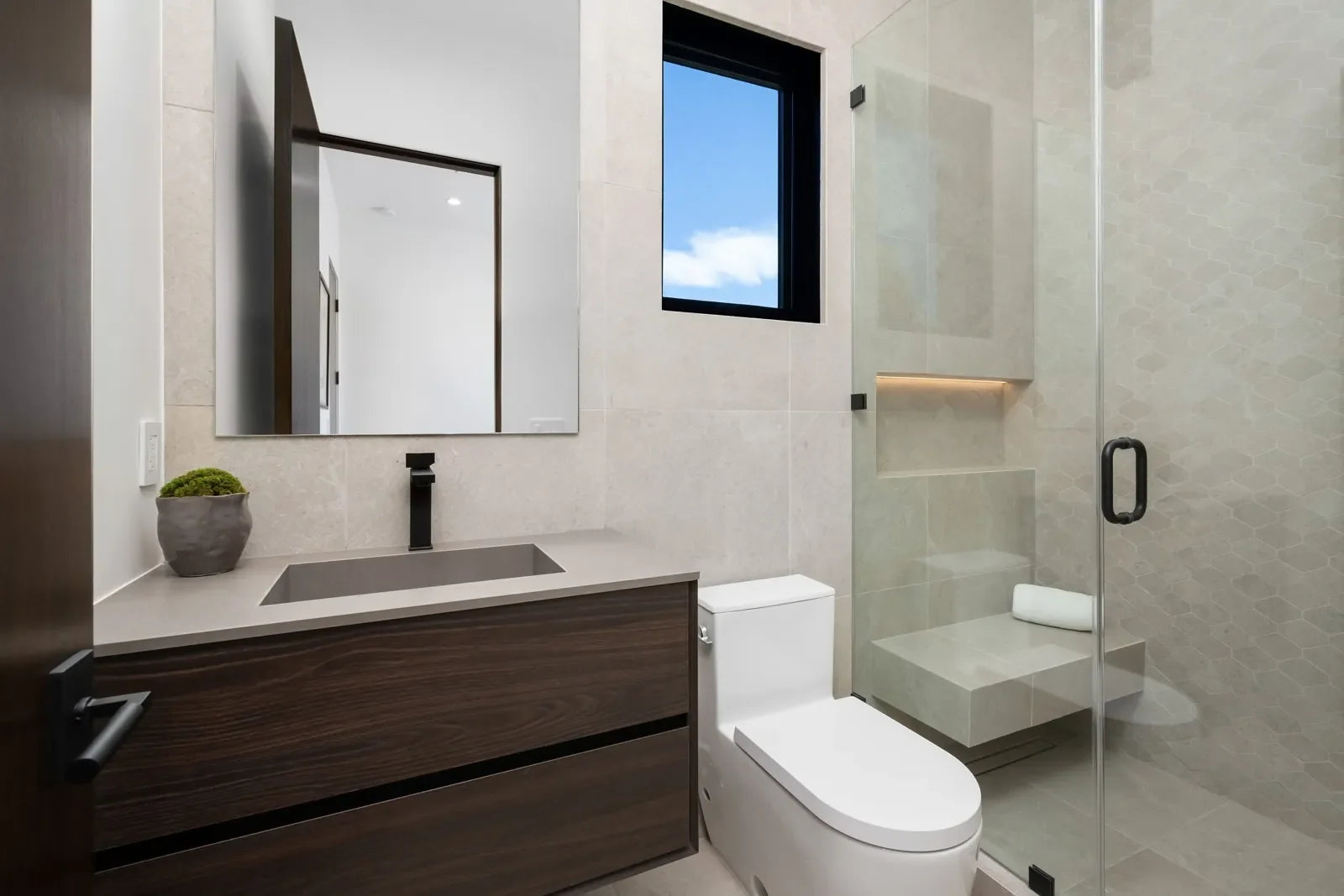 A sleek modern bathroom features a WaterSense-certified toilet designed for water efficiency.